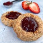Close-up of gluten-free thumbprint cookies with strawberry jam fillings.
